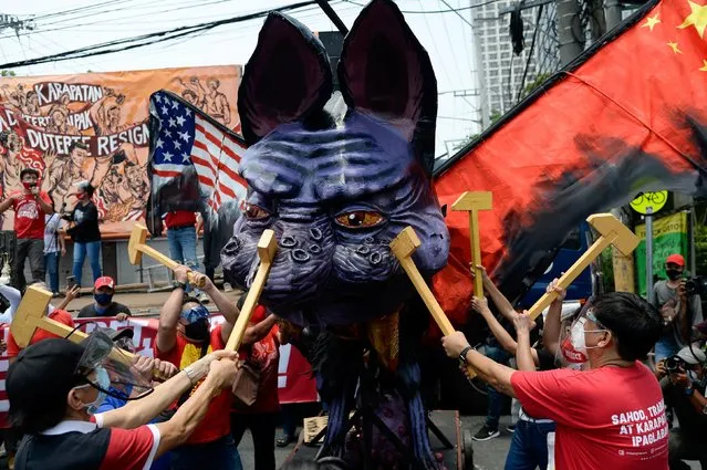 Demonstrators destroy an effigy depicting Philippine President Rodrigo Duterte as a mythical creature, during a Labor Day protest, in Quezon City, Metro Manila, Philippines, May 1, 2021. (Photo by Lisa Marie David/Reuters)