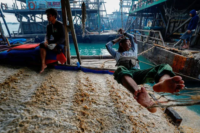 Amirudin, 43, a field supervisor of the state tin mining company PT Timah, rests on a makeshift hammock, on a tin pontoon off the coast of Toboali, on the southern shores of the island of Bangka, Indonesia, May 1, 2021. Timah has been ramping up production from the sea. Company data shows its proven tin reserve on land was 16,399 tonnes last year, compared with 265,913 tonnes offshore. (Photo by Willy Kurniawan/Reuters)