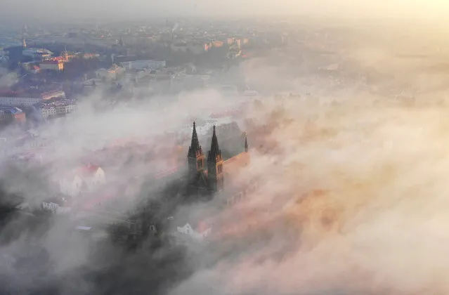 Mist flowing over the Basilica of St. Peter and St. Paul in Vysehrad, Prague on November 15, 2018. (Amos Chapple/Courtesy Images)