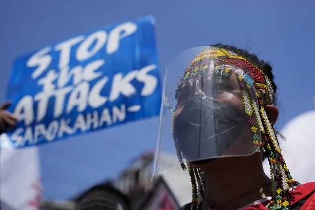 A protester wearing a traditional dress joins a rally outside the Malacanang palace in Manila, Philippines on Wednesday, June 30, 2021. The group has called for justice and accountability for the thousands who have died due to the government's anti-drug crackdown under the administration of Philippine President Rodrigo Duterte. (Photo by Aaron Favila/AP Photo)