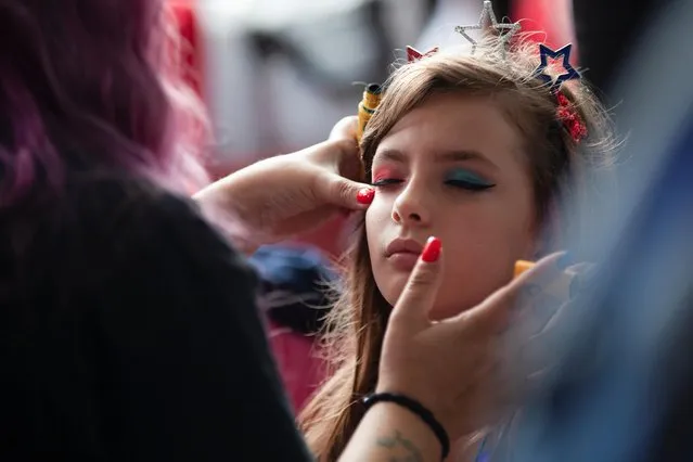 A girl has her face painted during the 236th annual Military, Civic, and Firemen’s Parade as part of 4th of July celebrations in Bristol, Rhode Island, U.S., July 5, 2021. (Photo by Quinn Glabicki/Reuters)