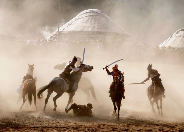 Riders fight in a mock battle on horseback on the opening day of the World Nomad Games in Kyrgyzstan on September 4, 2018. (Photo by Amos Chapple/Radio Free Europe/Radio Liberty)