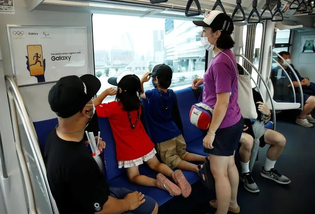 The Itoyama family wanted to buy tickets to watch the Tokyo Games but they were only able to buy one day tickets for the Yurikamome train, so that they can watch the BMX races at Ariake Urban Sports Park from the train and the nearest platform, in Tokyo, Japan July 30 2021. (Photo by Androniki Christodoulou/Reuters)
