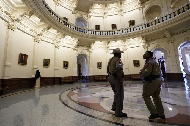 Texas Department of Safety officers stand watch over the Texas Capitol, Wednesday, August 11, 2021, in Austin, Texas. Officers of the Texas House of Representatives delivered civil arrest warrants for more than 50 absent Democrats on Wednesday as frustrated Republicans ratcheted up efforts to end a standoff over a sweeping elections bill that stretched into its 31st day. (Photo by Eric Gay/AP Photo)