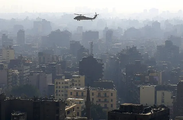 A military helicopter conducts an aerial patrol over Cairo, as part of heightened security measures ahead of the anniversary of the 25th of January uprising, in Egypt, January 17, 2016. (Photo by Asmaa Waguih/Reuters)