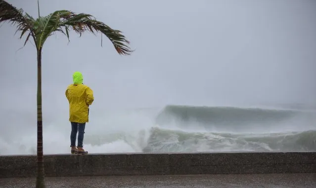 An onlooker watches the waves churned up by Tropical Storm Henri at Misquamicut Beach in Westerly, Rhode Island, USA, 22 August 2021. Tropical Storm Henri is expected to make landfall near the Connecticut and Rhode Island boarders later in the day. (Photo by C.J. Gunther/Rex Features/Shutterstock)