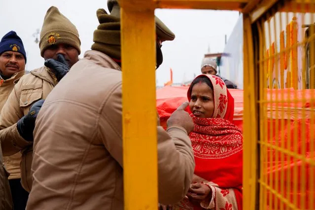 Police officers ask a Hindu devotee to leave the area of the Hindu Lord Ram temple before its inauguration in Ayodhya, India on January 22, 2024. (Photo by Adnan Abidi/Reuters)