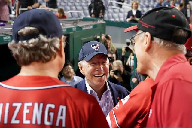 U.S. President Joe Biden speaks with members of the Republicans team as he attends the annual Congressional Baseball Game at Nationals Park in Washington, U.S., September 29, 2021. (Photo by Kevin Lamarque/Reuters)