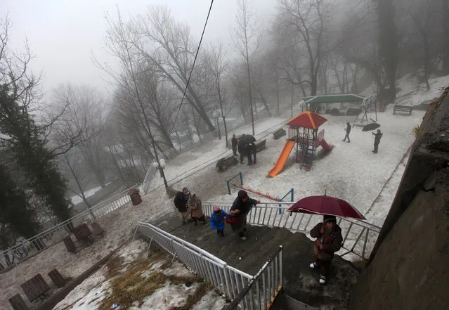 Tourists visit on a cold winter day after snow fall in the hill-resort town of Murree, northeast of capital Islamabad, Pakistan, January 25, 2017. (Photo by Faisal Mahmood/Reuters)