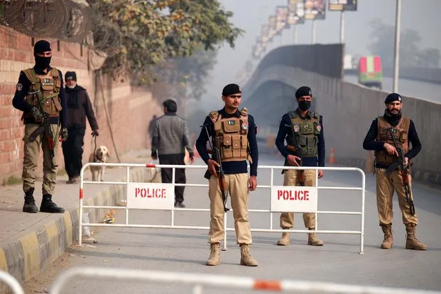 Pakistan police stand guard at a checkpoint after intensified security following a court verdict imprisoning former Prime Minister Imran Khan to 10 years, in Peshawar, Pakistan, 30 January 2024. Former Pakistani Prime Minister Imran Khan and his top aide Shah Mahmood Qureshi have been sentenced to 10 years in jail for leaking official secrets, just days before the general elections scheduled for 08 February. The sentencing took place following a trial conducted within the prison where Khan has been detained, despite previous rulings declaring the jail trial as illegal. Khan and Qureshi are accused of leaking diplomatic correspondence between Washington and Islamabad during Khan's tenure as prime minister. The Pakistan Tehreek-e-Insaf (PTI) party has vowed to challenge the decision in a higher court. The case has raised serious questions about the transparency of the trial and has been marred by allegations of pre-vote rigging, with Khan's party facing suppression. (Photo by Arshad Arbab/EPA/EFE)
