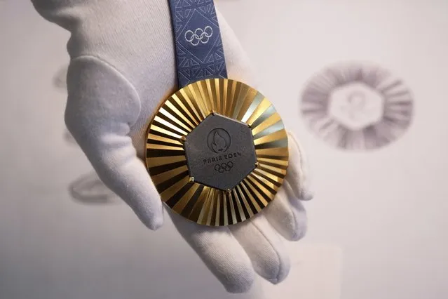 The Paris 2024 Olympic gold medal is presented to the press, in Paris, Thursday, February 1, 2024. A hexagonal, polished piece of iron taken from the Eiffel Tower is being embedded in each gold, silver and bronze medal that will be hung around athletes' necks at the July 26-Aug. 11 Paris Games and Paralympics that follow. (Photo by Thibault Camus/AP Photo)