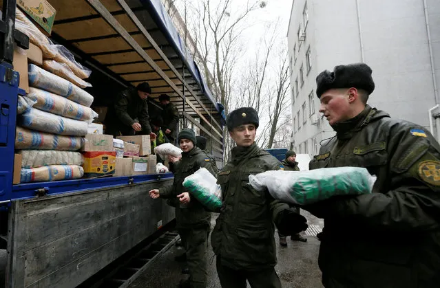 Members of the Ukrainian National Guard load humanitarian aid parcels for the government-held industrial town of Avdiyivka to a truck in Kiev, Ukraine February 3, 2017. (Photo by Valentyn Ogirenko/Reuters)