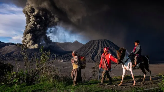Journeys and adventures – remarkable artwork – Life Goes On. There were continual eruptions at Mount Bromo for exactly one year from 12 November 2015 to 12 November 2016. The volcano emitted ash that disrupted flights and local tourism. Despite the volcanic activity people who live nearby carry on as usual. Bromo Tengger Semeru national park, East Java. (Photo by Riksa Dewantara/SIPA Contest)