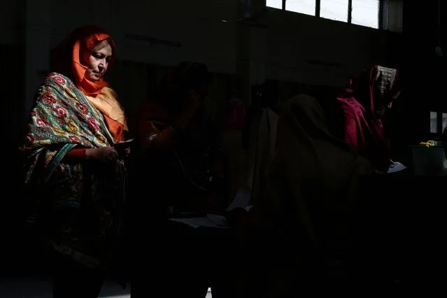 A voter registers to vote at a polling station in a school during a general election, in Islamabad, Pakistan on February 8, 2024. (Photo by Gabrielle Fonseca Johnson/Reuters)