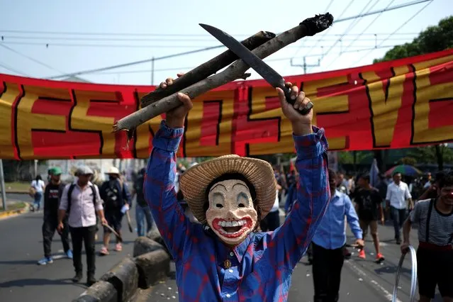 A performer participates in a May Day rally in San Salvador, El Salvador on May 1, 2019. (Photo by Jose Cabezas/Reuters)