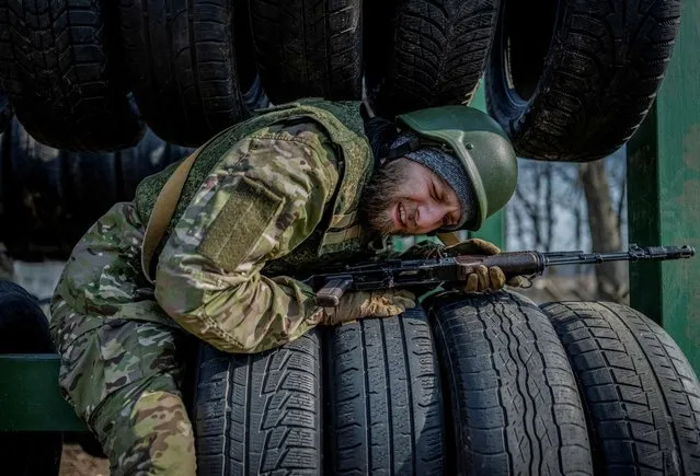 A volunteer who aspires to join the 3rd Separate Assault Brigade of the Ukrainian Armed Forces takes part in a basic training, in Kyiv region, Ukraine on March 5, 2024. (Photo by Viacheslav Ratynskyi/Reuters)