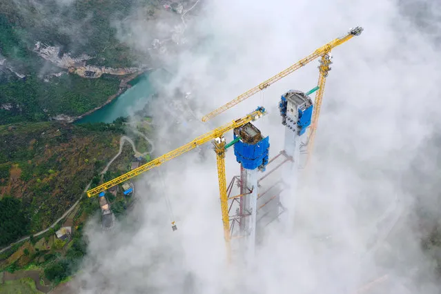 Aerial photo taken on November 21, 2021 shows the main tower of Tongzi River grand bridge in southwest China's Guizhou Province. The main tower of the Tongzi River Grand Bridge was capped on Sunday. The 1,422-meter-long bridge is an important part of the Jinsha-Renhuai-Tongzi Highway. (Photo by Xinhua News Agency/Rex Features/Shutterstock)