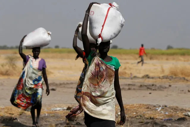 Women carry sacks of food in Nimini village, Unity State, northern South Sudan, February 8, 2017. (Photo by Siegfried Modola/Reuters)