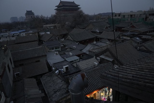 A resident walks past an old district in Beijing, China, Saturday, November 27, 2021. (Photo by Ng Han Guan/AP Photo)