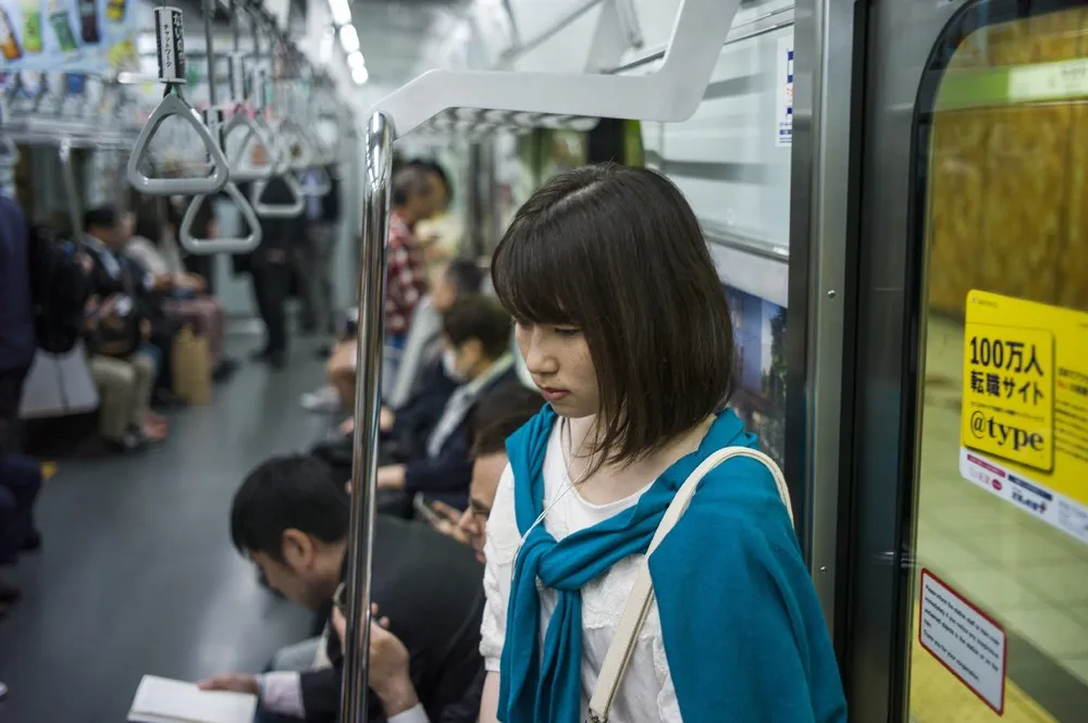 Next picture →. A commuter rides the subway at Shinjuku station in Tokyo on...
