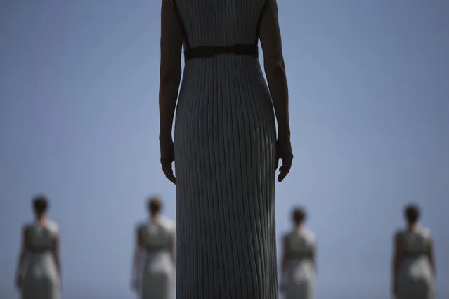 High Priestess Katerina Lehou stands in front of a line of priestesses during the dress rehearsal for the lighting of the Rio Olympics flame, in Ancient Olympia, southern Greece, on Wednesday, April 20, 2016. The meticulously choreographed ceremony will be repeated Thursday in the ruined birthplace of the ancient Olympics in southern Greece, in the presence of top International Olympic Committee and Rio organizing officials. That will touch off a relay that will conclude with the Rio Games opening ceremony in August. (Photo by Petros Giannakouris/AP Photo)