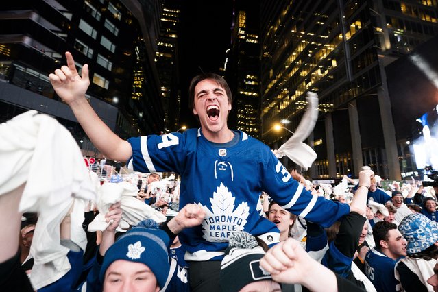 Fans react after a Toronto Maple Leafs goal while watching the Maple Leafs play the Boston Bruins in Game 6 of first-round NHL hockey playoff series on a videoscreen outside Scotiabank Arena in Toronto, Thursday, May 2, 2024. (Photo by Arlyn McAdorey/The Canadian Press via AP Photo)