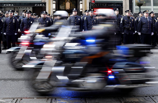 Police officers on motorcycles move down Fifth Avenue surrounded by thousands of police officers on Fifth Avenue as part of the funeral precession for fallen NYPD Police Officer Wilbert Mora after funeral services at St. Patrick's Cathedral in New York City on Wednesday, February 2, 2022. Officers Wilbert Mora and Jason Rivera were gunned down in an ambush on a domestic violence call at a Harlem apartment. (Photo by John Angelillo/UPI/Rex Features/Shutterstock)