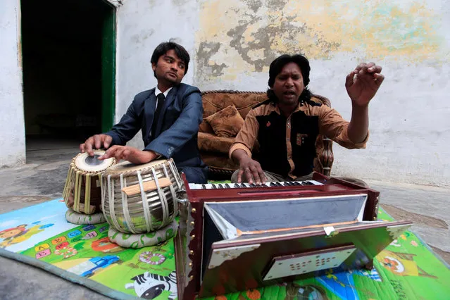 Nazar Gill, (R) a local singer, practices a song along with his brother at his residence in Rawalpindi, Pakistan, February 2, 2017. (Photo by Faisal Mahmood/Reuters)