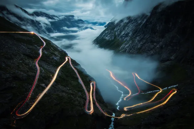 Light from car headlights streak across the hills of Bø, Møre og Romsdal, Norway. (Photo by Christoph Schaarschmidt/2016 National Geographic Travel Photographer of the Year Contest)
