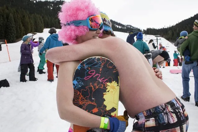 Claire McGuire (L) gets a hug after winning the women's snowboard division of the Bikini & Board Shorts Downhill at Crystal Mountain, a ski resort near Enumclaw, Washington April 19, 2014. Skiers and snowboarders competed for a chance to win one of four season's passes. (Photo by David Ryder/Reuters)