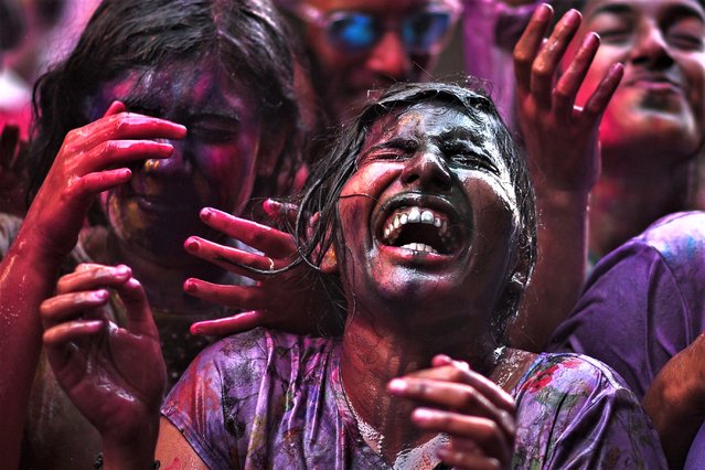 Revelers stained with colored powder cheer during the Holi festival celebrations in Chennai, India, 08 March 2023. Holi, also known as the “Festival Of Colors” is an ancient Indian Hindu festival symbolizing the victory of good over evil and marking the arrival of spring. It is celebrated with joyful gatherings during which revelers cover each other in colored powders. (Photo by Idrees Mohammed/EPA/EFE)