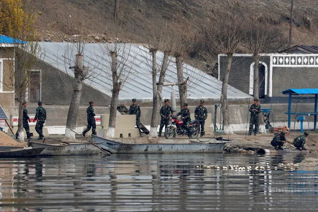 North Korean soldiers are seen along the banks of the Yalu River in Sinuiju, North Korea, which borders Dandong in China's Liaoning province, April 16, 2017. (Photo by Aly Song/Reuters)
