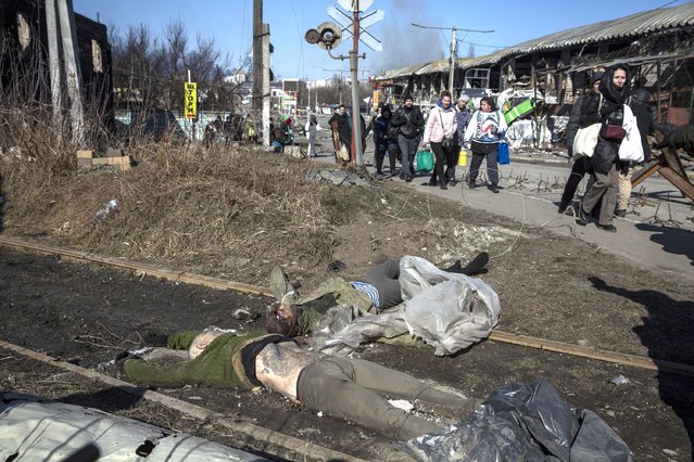 The bodies of two Russian soldiers are seen inside the the Ukrainian city of Irpin on March 10,2022 as people flee for safety. (Photo by Heidi Levine for The Washington Post)