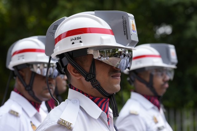 Traffic police personnel wear special-issued helmets with inbuilt air-conditioning units in Lucknow, India, Thursday, June 27, 2024. The state of Uttar Pradesh has experienced extreme temperatures this summer. (Photo by Rajesh Kumar Singh/AP Photo)