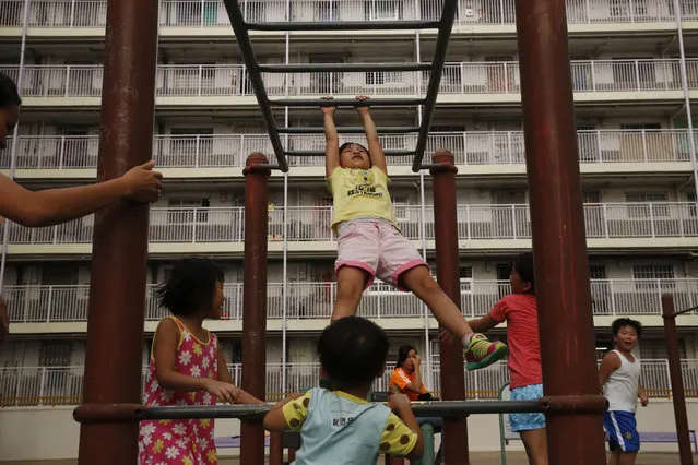 In this Tuesday, July 7, 2015 photo, children play at a park in a public housing complex in Hong Kong. (Photo by Kin Cheung/AP Photo)