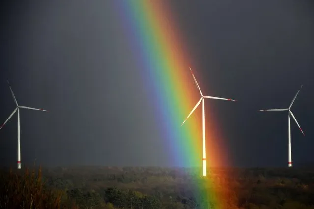 A rainbow is seen behind wind turbines near Breuna, western Germany on February 17, 2022. (Photo by Ina Fassbender/AFP Photo)