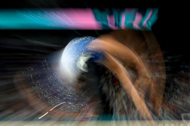 In this photo made with a slow exposure, Simone Biles, of the United States, competes during the women's artistic gymnastics individual balance beam finals at Bercy Arena at the 2024 Summer Olympics, Monday, August 5, 2024, in Paris, France. (Photo by Francisco Seco/AP Photo)