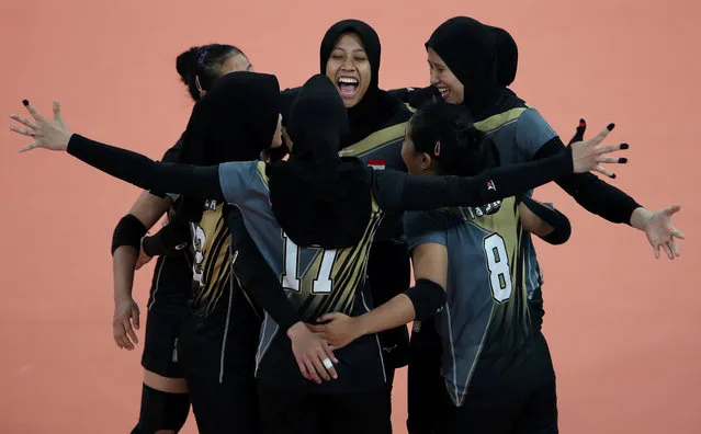 The Indonesia players celebrate a point during the match against Vietnam during the women's volleyball preliminary round at the Southeast Asian Games in Pasig, Philippines on December 5, 2019. (Photo by Ann Wang/Reuters)