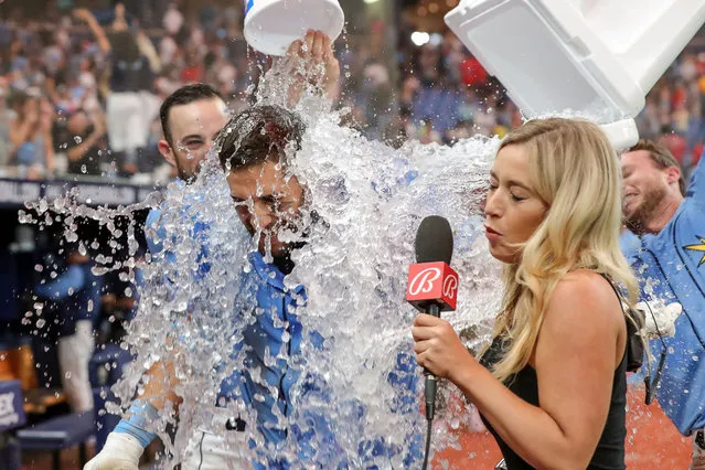 Kevin Kiermaier #39 of the Tampa Bay Rays is doused with water after hitting a game-winning home run against the Boston Red Sox during the 10th inning in a baseball game at Tropicana Field on April 23, 2022 in St. Petersburg, Florida. (Photo by Mike Carlson/Getty Images)