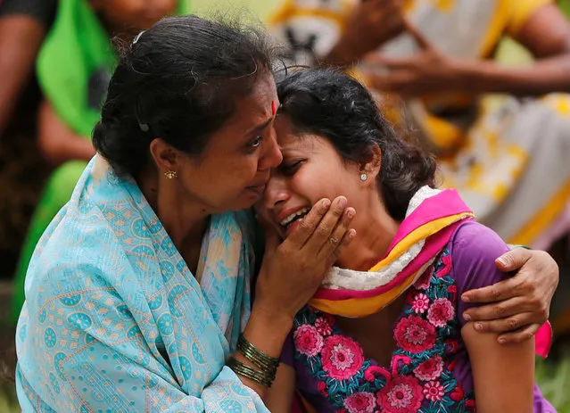 Relatives of passengers injured in a traffic accident cry outside a hospital in Panvel, India, June 5, 2016. (Photo by Shailesh Andrade/Reuters)