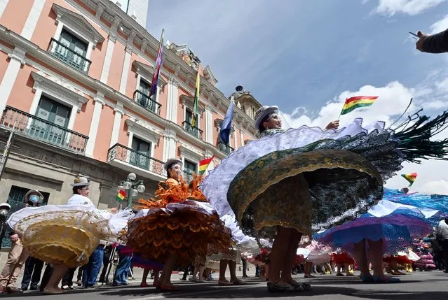 Morenada dancers dance at the Plaza de Armas during the celebrations of the Morenada National Day in La Paz, Bolivia on September 7, 2021. (Photo by Aizar Raldes/AFP Photo)