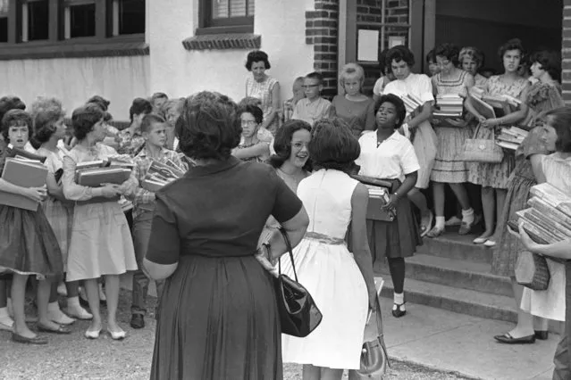 Veronica Pearson, 13, first black girl to attend previously white Rison Junior High School, leaves the building in Huntsville, Ala., September 9, 1963, as her mother waits, left. Rison and three other schools here were integrated today without incident. Friday, blacks were turned away by Alabama state patrolmen. (Photo by Charles Kelly/AP Photo)