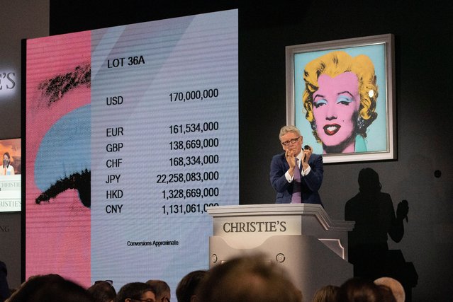 Christie's auctioneer claps after ending the auction of “Shot Sage Blue Marilyn” by Andy Warhol which sold for $195 million dollars during an Evening Sale of works from The Collection of Thomas and Doris Amman at Christie's Auction House in New York, New York, USA, 09 May 2022. (Photo by Sarah Yenesel/EPA/EFE)