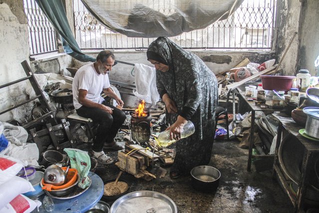 Palestinian Abu Shamale family, whose house was destroyed after an Israeli attack on the Sheikh Zayed Towers, tries to earn a living by making dessert from stale bread on wood fire in Jabalia Refugee Camp, Deir Al Balah, Gaza on August 19, 2024. (Photo by Mahmoud ssa/Anadolu via Getty Images)