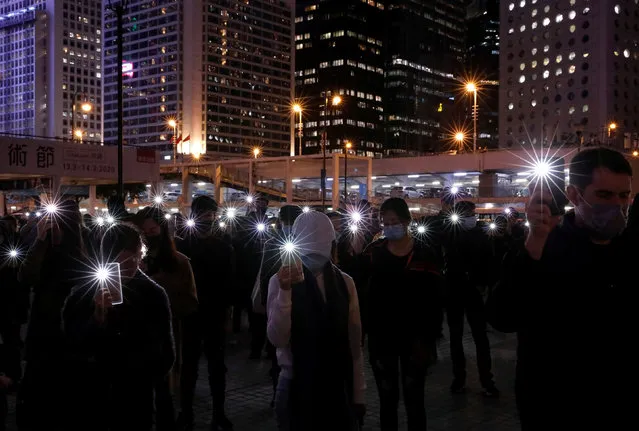 Anti-government demonstrators use the flashlights of their mobile phones as they take part in a protest in Edinburgh Place in Hong Kong, China, December 30, 2019. (Photo by Navesh Chitrakar/Reuters)