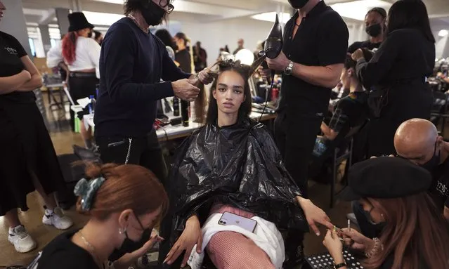 A model gets her hair and nails done backstage in preparation for the LaQuan Smith fashion show during New York Fashion Week on Thursday, September 9, 2021, n New York. (Photo by Charles Sykes/Invision/AP Photo)