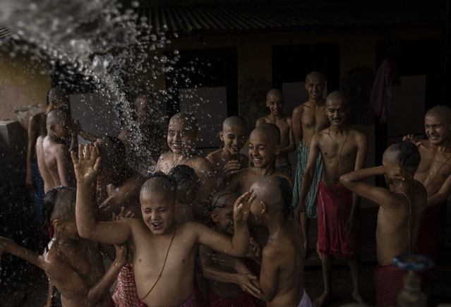 A group of Nepalese students from a Hindu school attend a mass worship ceremony to mark the Janai Purnima Festival celebrations on the premises of Pashupatinath temple in Kathmandu, Nepal, 19 August 2024. During Janai Purnima, also known as the Sacred Thread festival or Rakshya Bandhan festival, Hindu men, especially the Brahmans and Chettris, perform their annual change of Janai, sacred threads worn across the chest or tied around the wrist. Purified by mantras, the thread symbolizes protection, according to Hindu belief. The festival also marks the end of the monsoon season. (Photo by Narendra Shrestha/EPA)