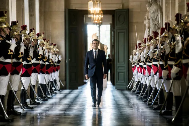 French President Emmanuel Macron walks through the Galerie des Bustes (Busts Gallery) to access the Versailles Palace's hemicycle for a special congress gathering both houses of parliament (National Assembly and Senate), near Paris, France, July 3, 2017. (Photo by Etienne Laurent/Reuters)