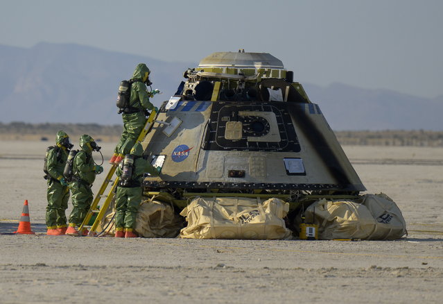 A handout picture made available by the National Aeronautics and Space Administration (NASA) shows, NASA teams working around Boeing’s CST-100 Starliner spacecraft after it landed at White Sands Missile Range’s Space Harbor, in Las Cruces, New Mexico, 25 May 2022. Boeing’s Orbital Flight Test-2 (OFT-2) is Starliner’s second uncrewed flight test to the International Space Station as part of NASA's Commercial Crew Program. OFT-2 serves as an end-to-end test of the system's capabilities. (Photo by Bill Ingalls/NASA/EPA/EFE)