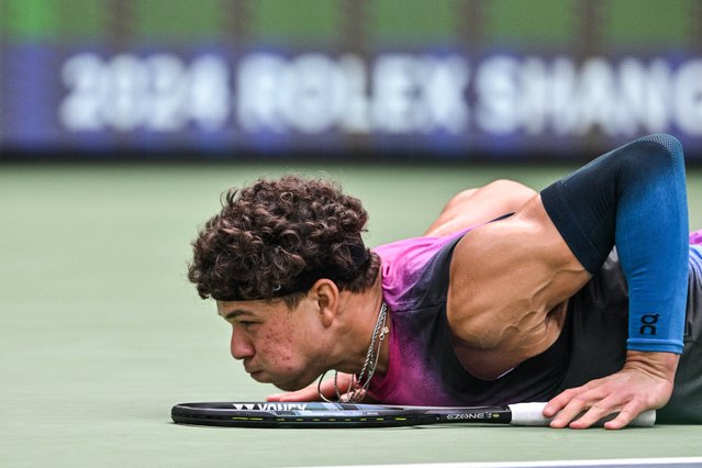 USA's Ben Shelton reacts after falling down during his game against Canada's Denis Shapovalov in their men's singles match at the Shanghai Masters tennis tournament in Shanghai on October 4, 2024. (Photo by Hector Retamal/AFP Photo)